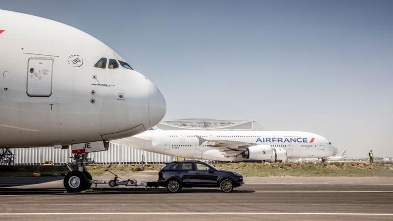 Porsche Cayenne pulling a monstrous Airbus A380 plane
